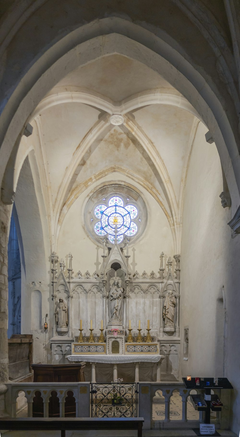 the interior of a church with a stained glass window