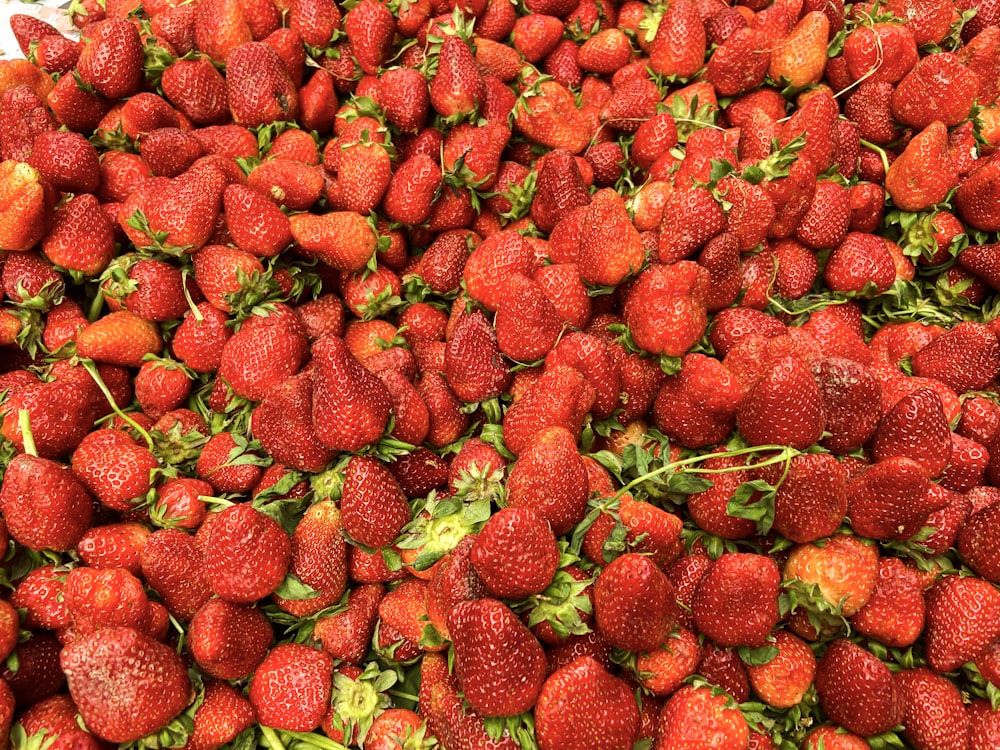 a pile of strawberries sitting on top of each other