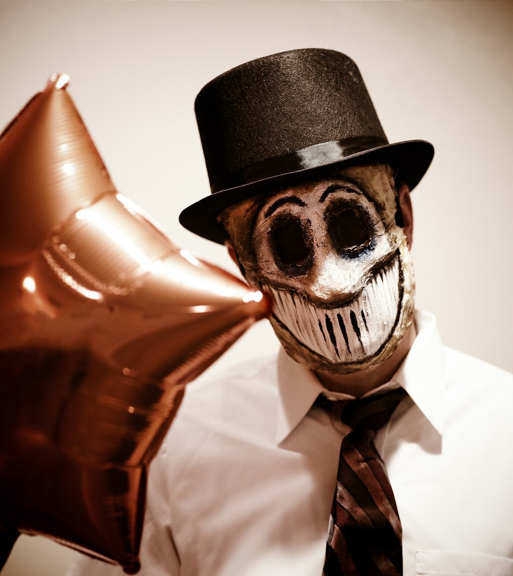 a man in a top hat holding a star shaped balloon