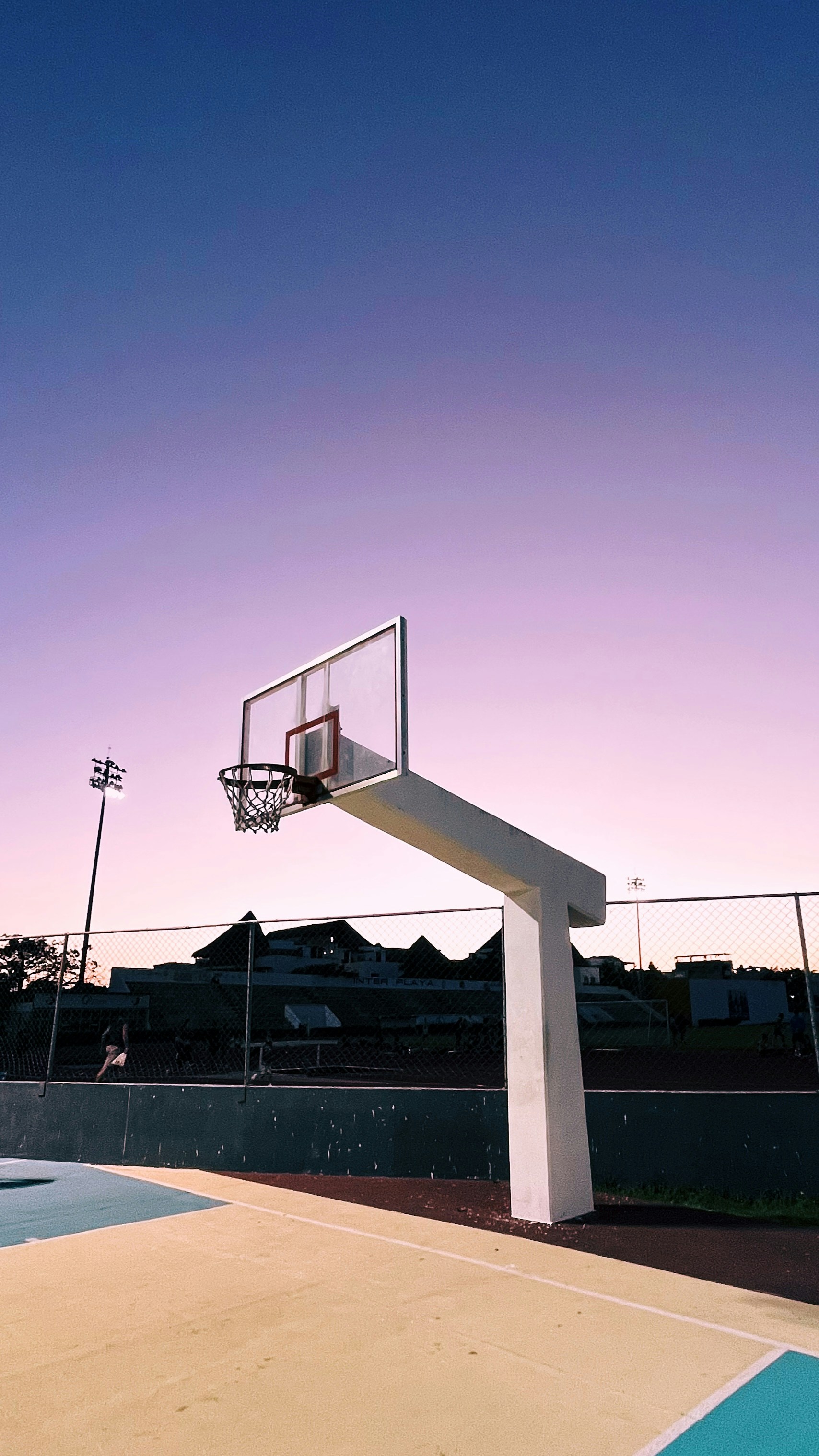 a basketball court with a basketball going through the hoop