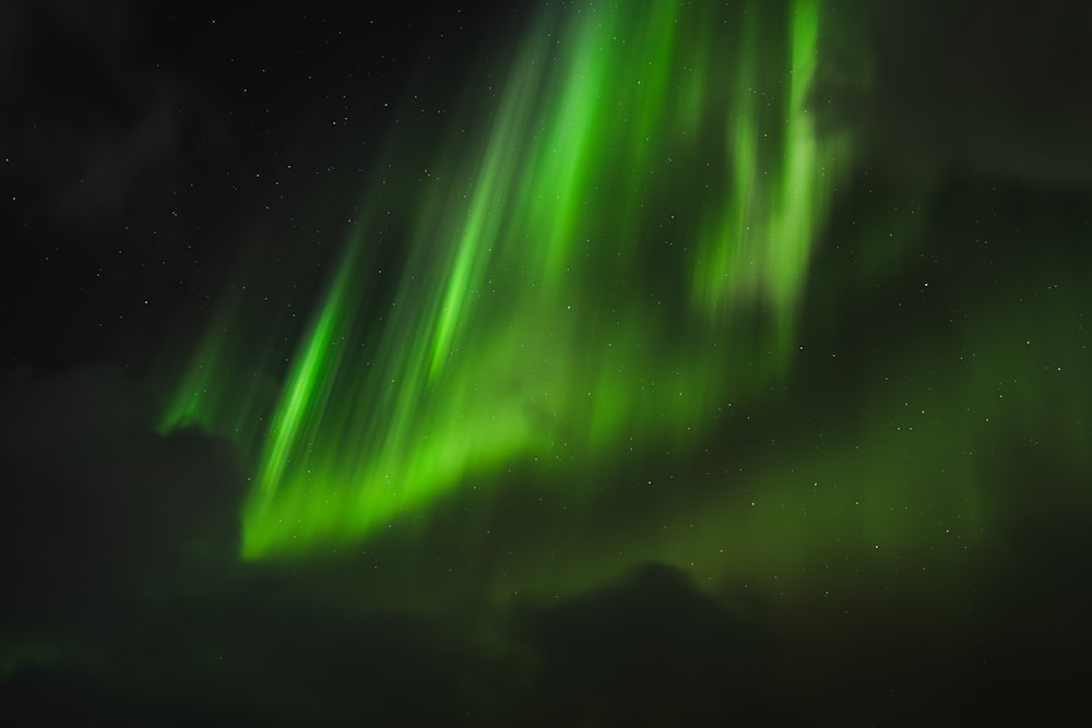 a bright green aurora bore in the night sky