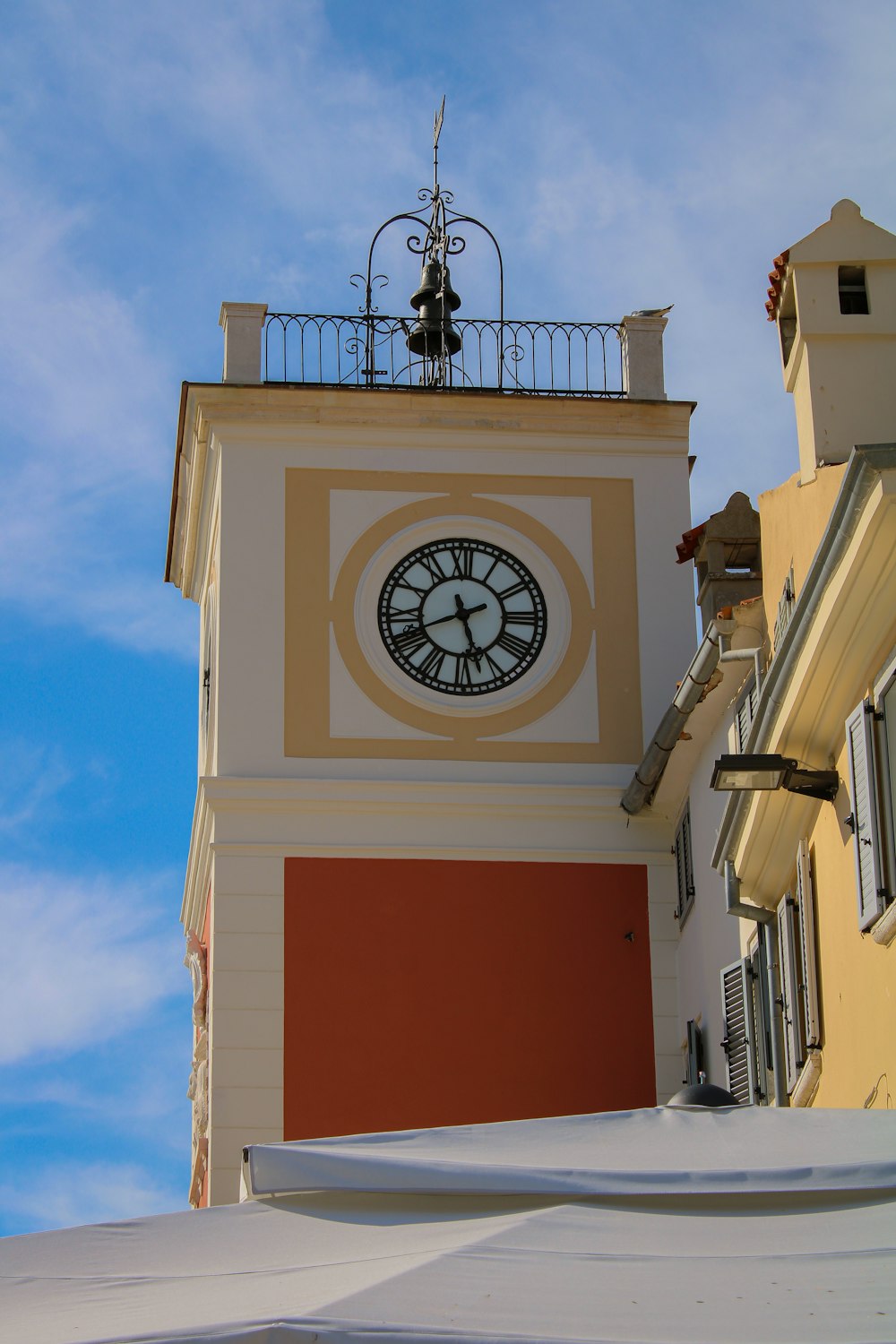 a clock tower with a weather vane on top of it