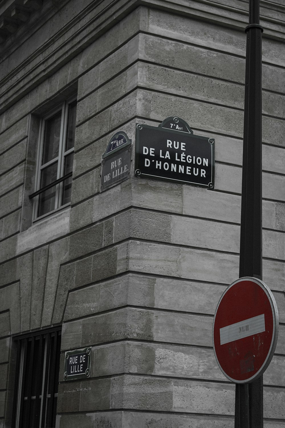 a street sign on a pole in front of a building