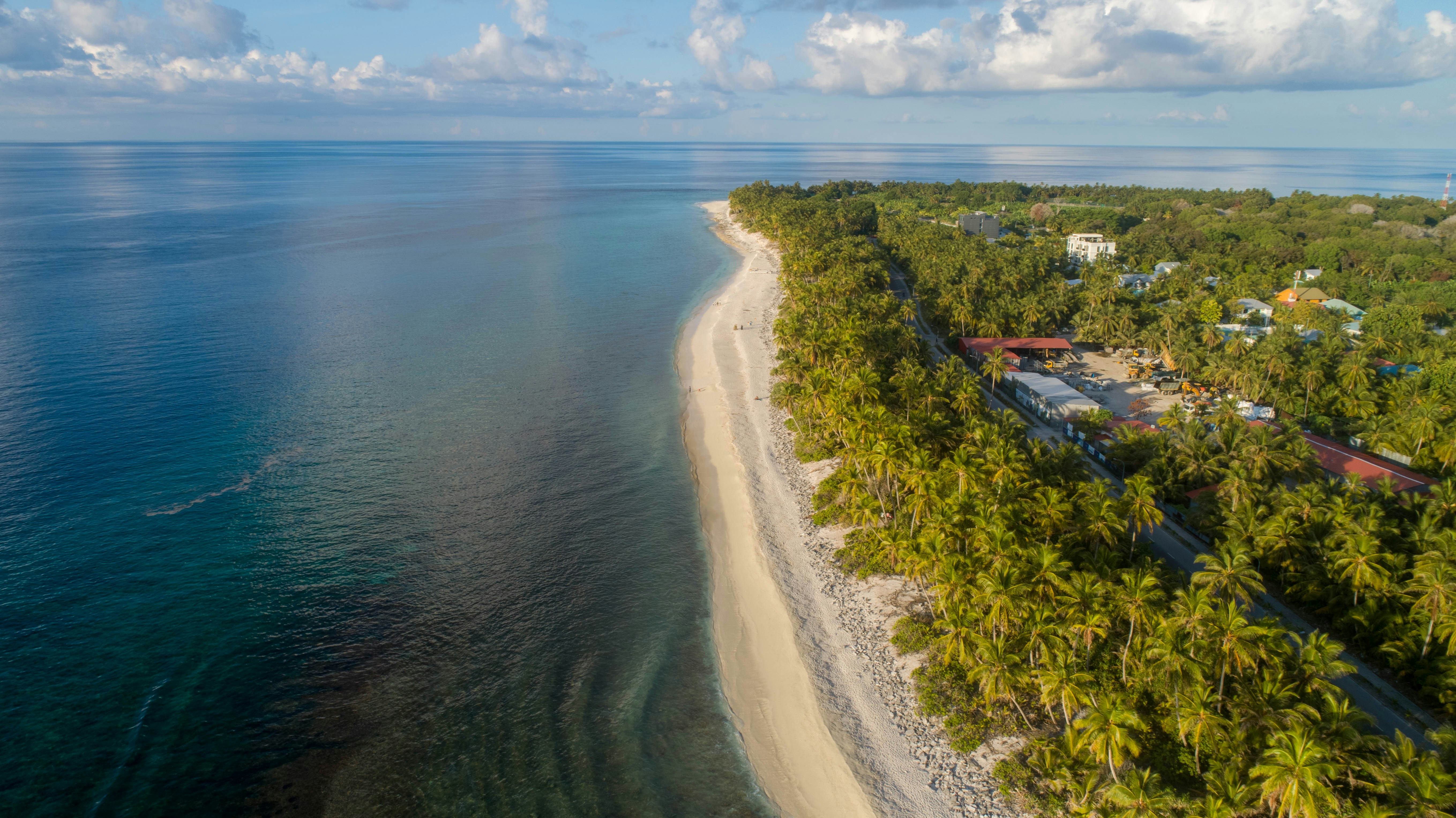 an aerial view of a beach and a tropical island