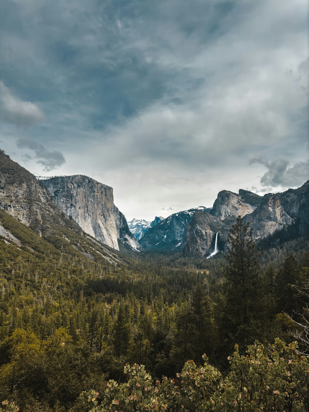 a view of a valley with mountains in the background