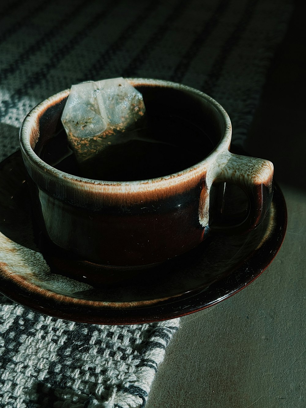 a cup of tea on a saucer on a table