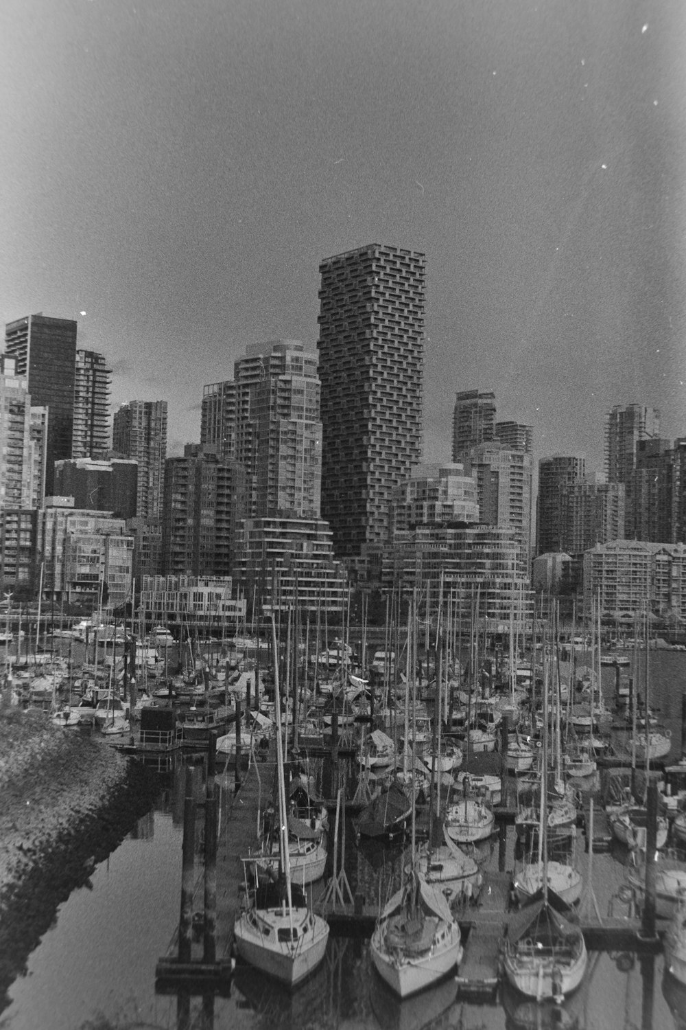 a black and white photo of boats in a harbor