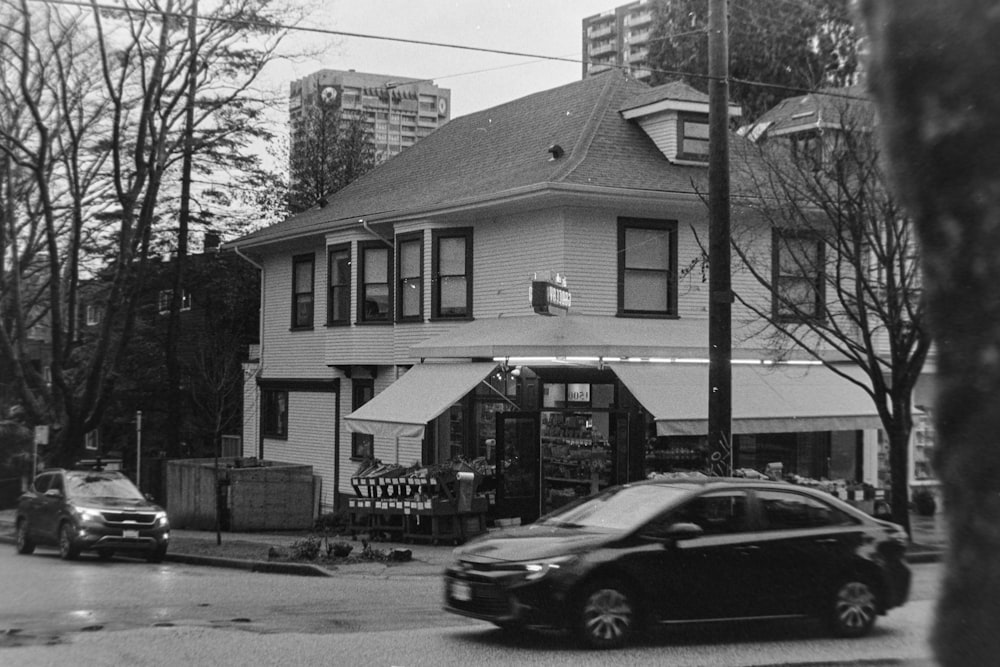 a black and white photo of a building on a street corner