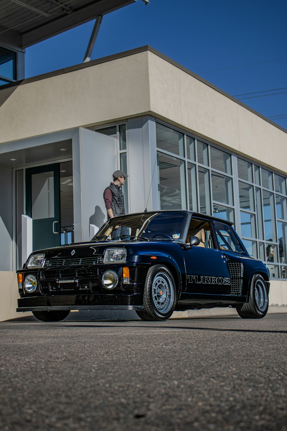 a black car parked in front of a building