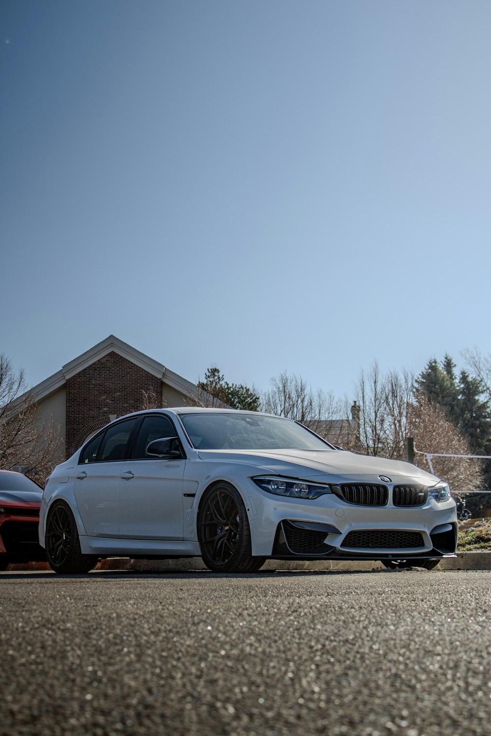 a white car parked in front of a house