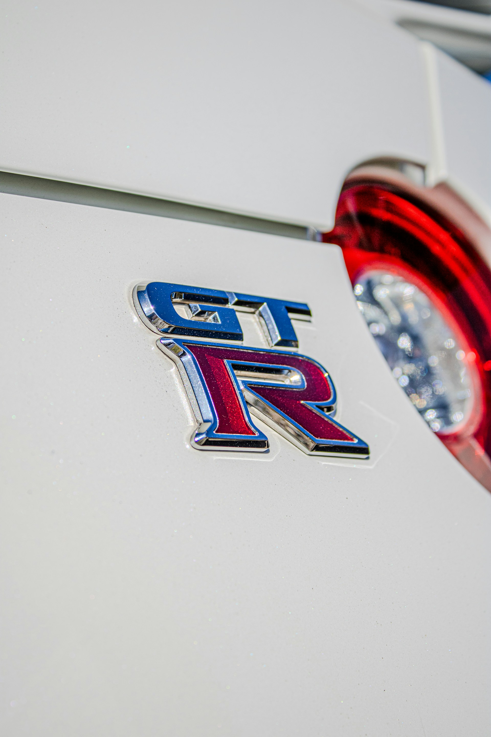 a close up of the tail end of a white car