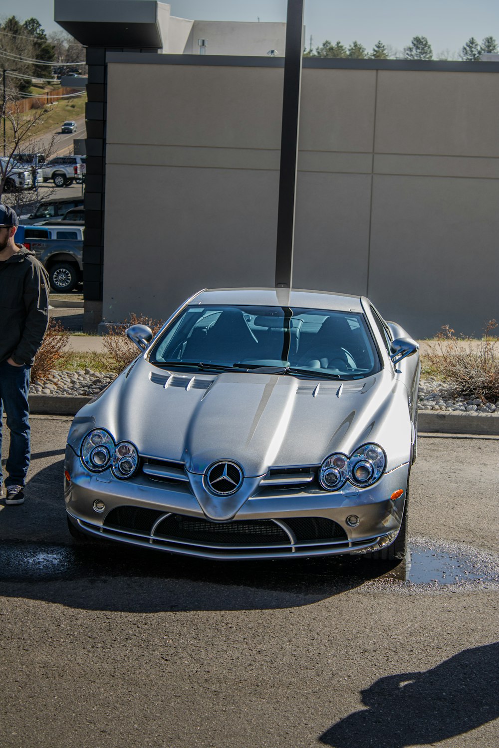 a silver sports car parked in a parking lot