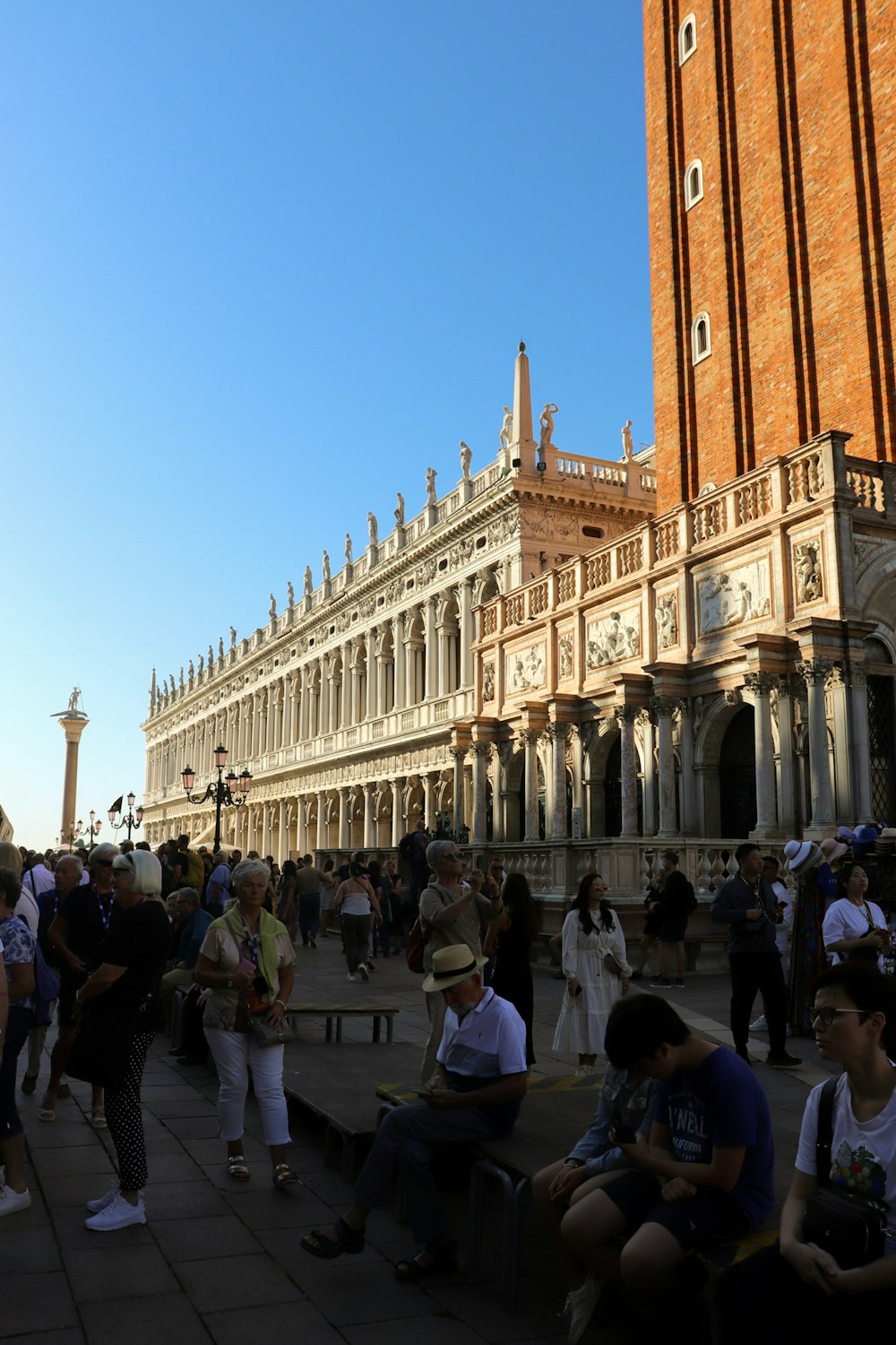 a group of people sitting on benches in front of a building