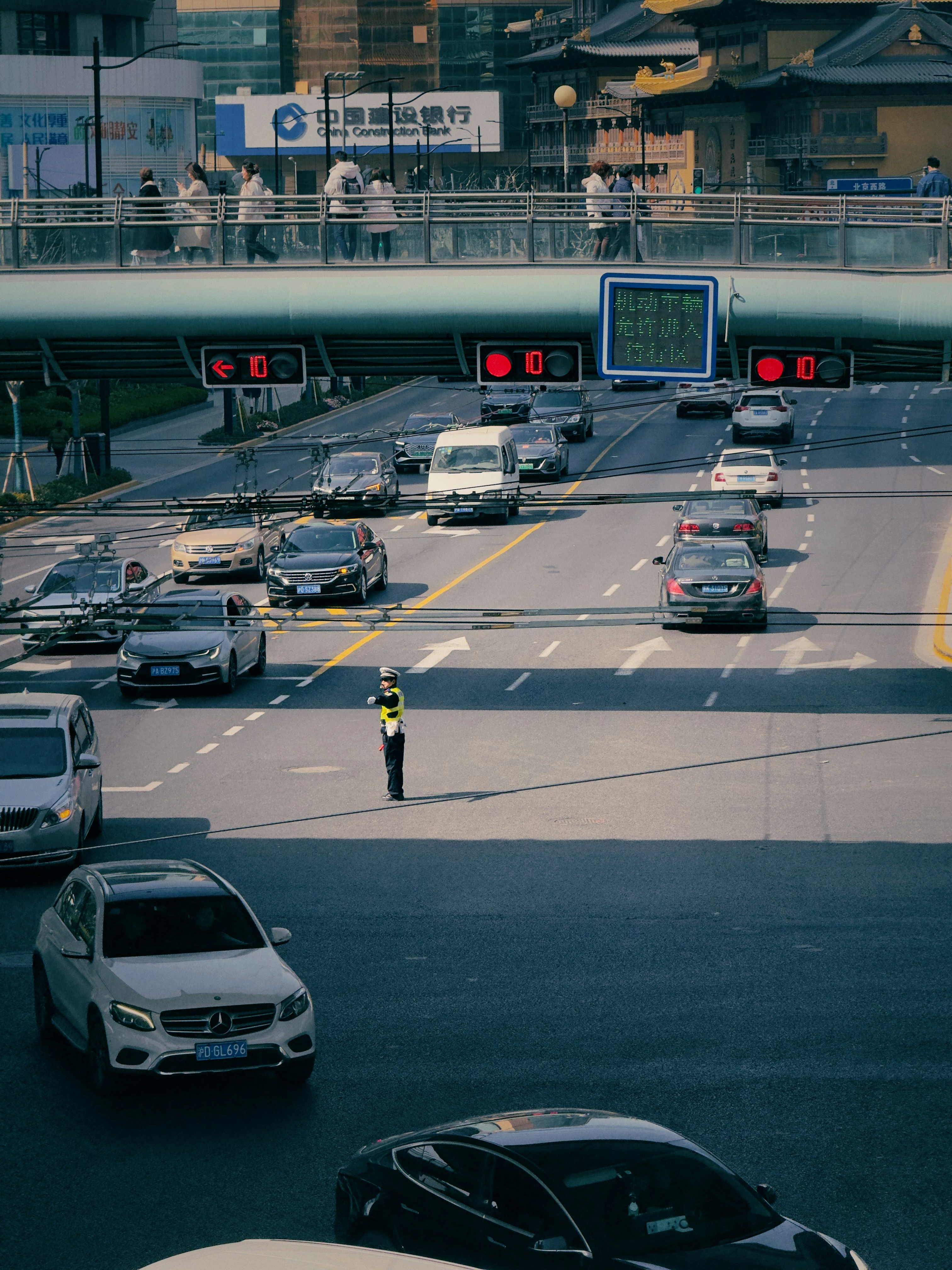 a man standing in the middle of a busy highway
