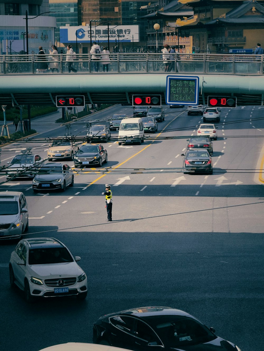 a man standing in the middle of a busy highway