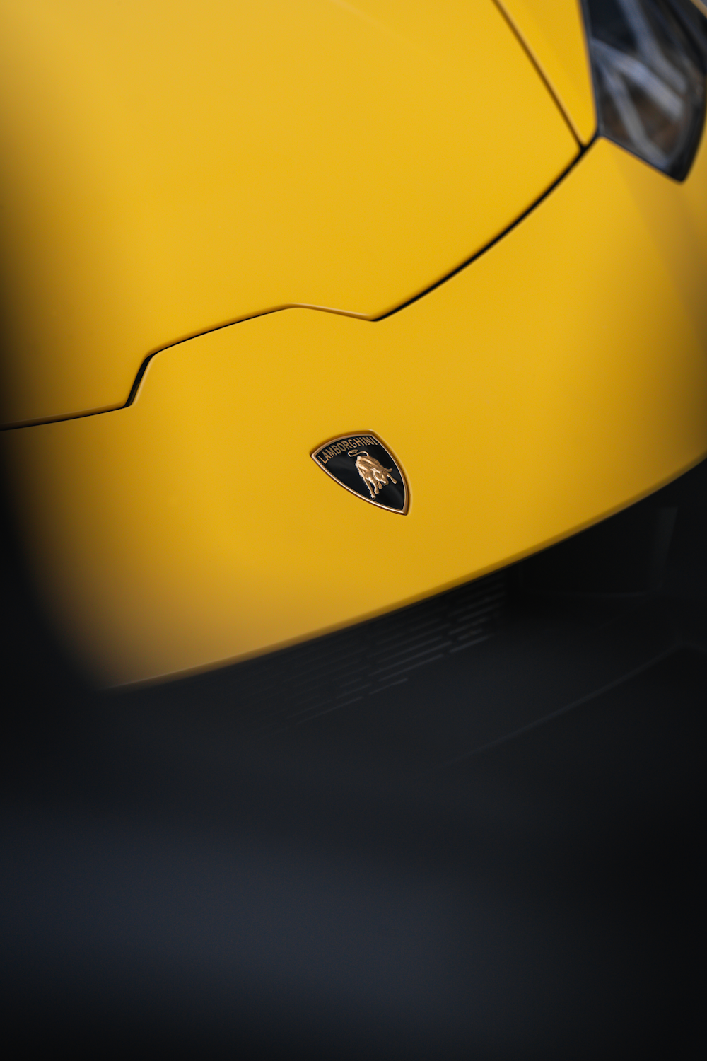 a close up of a yellow sports car