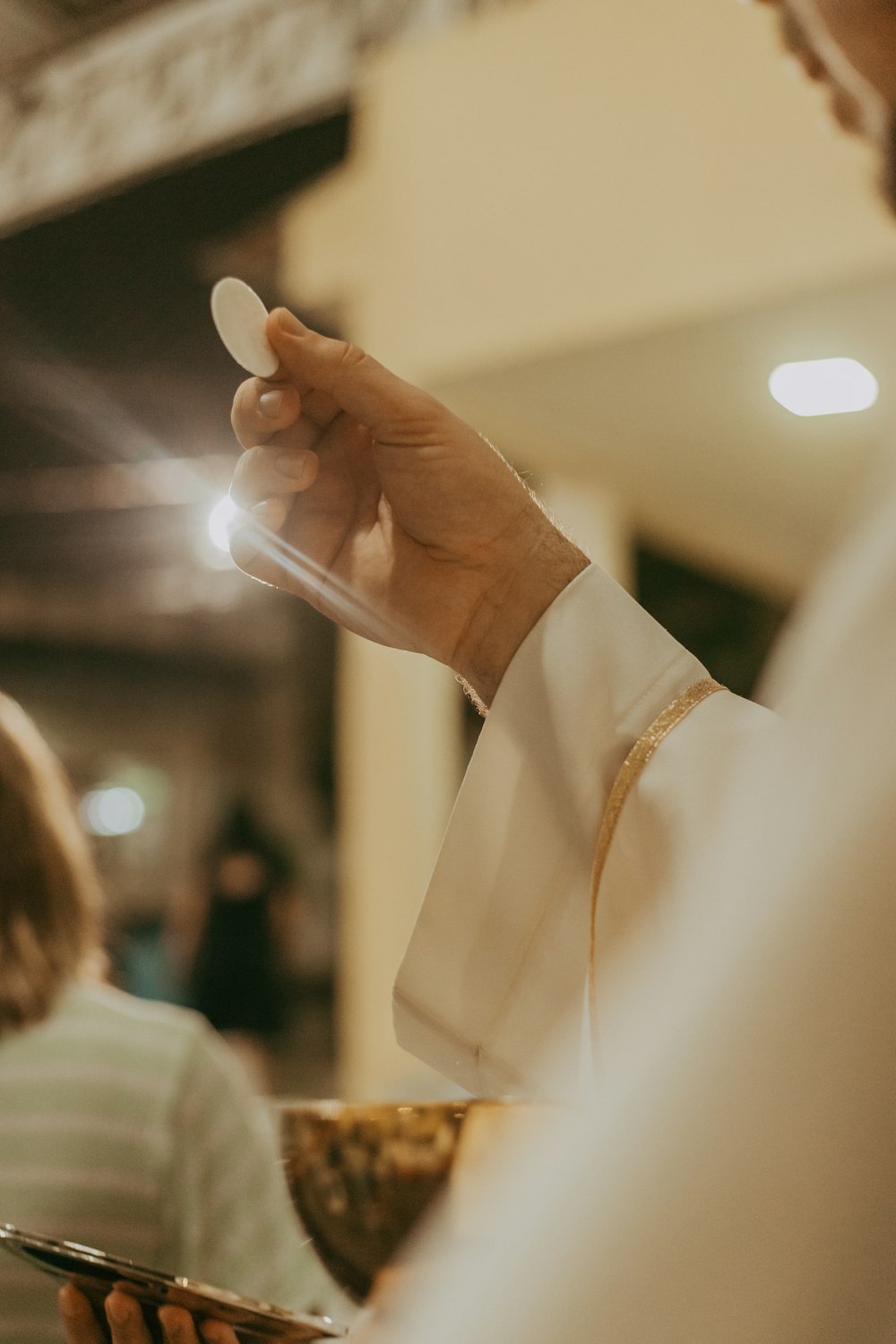 a priest is holding a tablet in his hand
