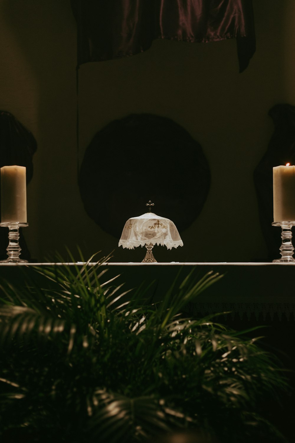 a table topped with a cake covered in white frosting