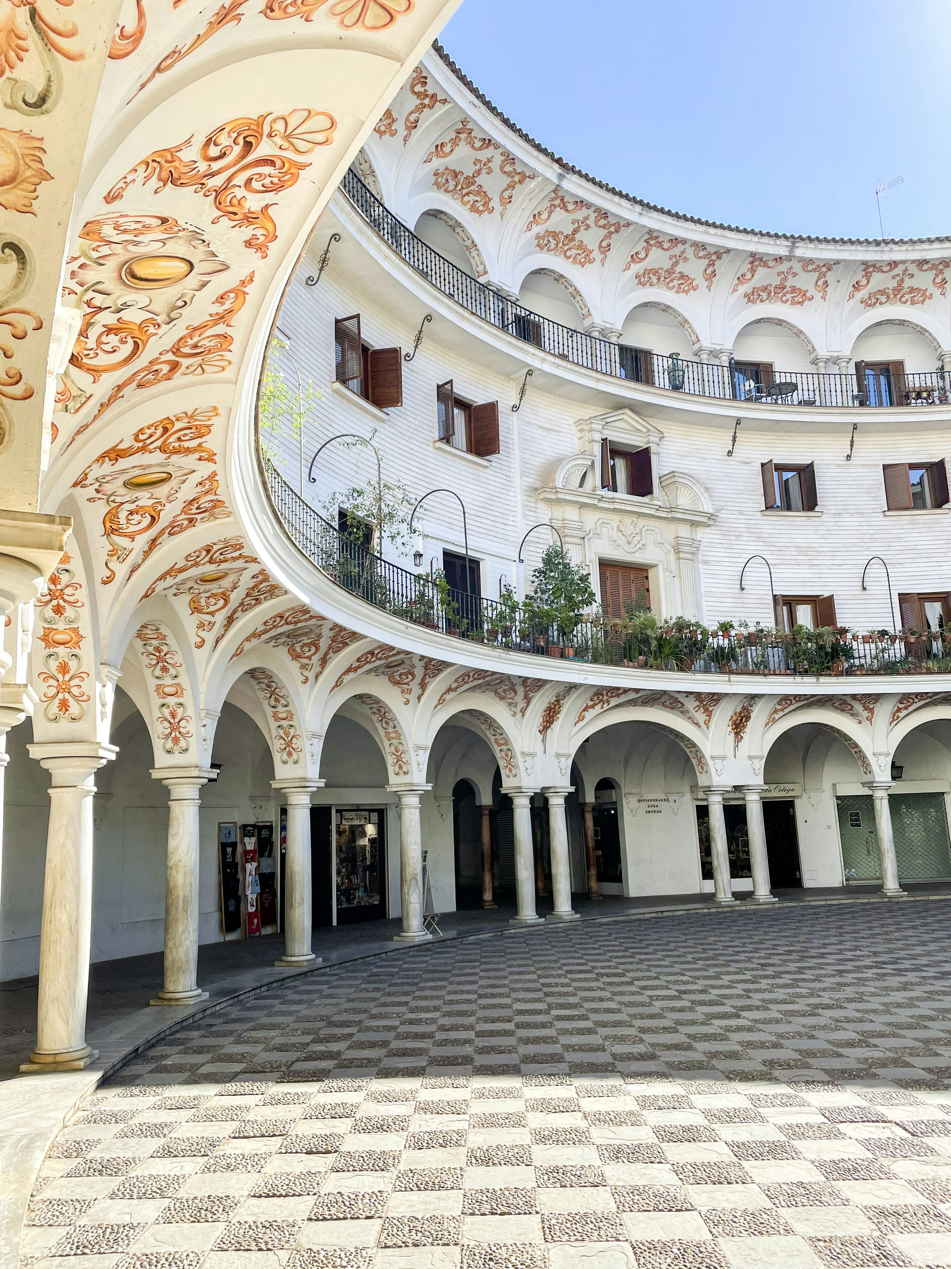 a building with a circular courtyard and a tiled floor