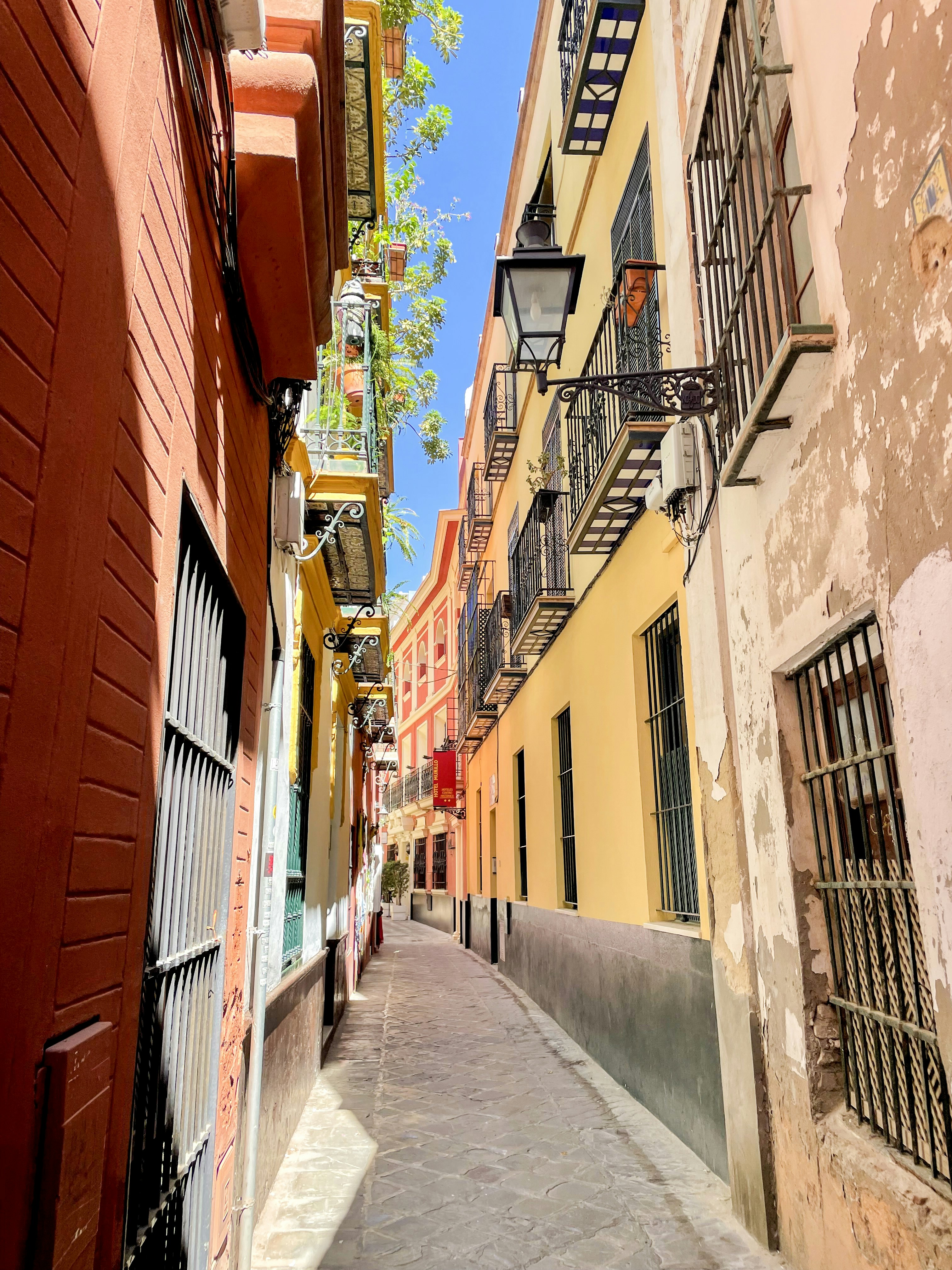 a narrow city street with buildings on both sides
