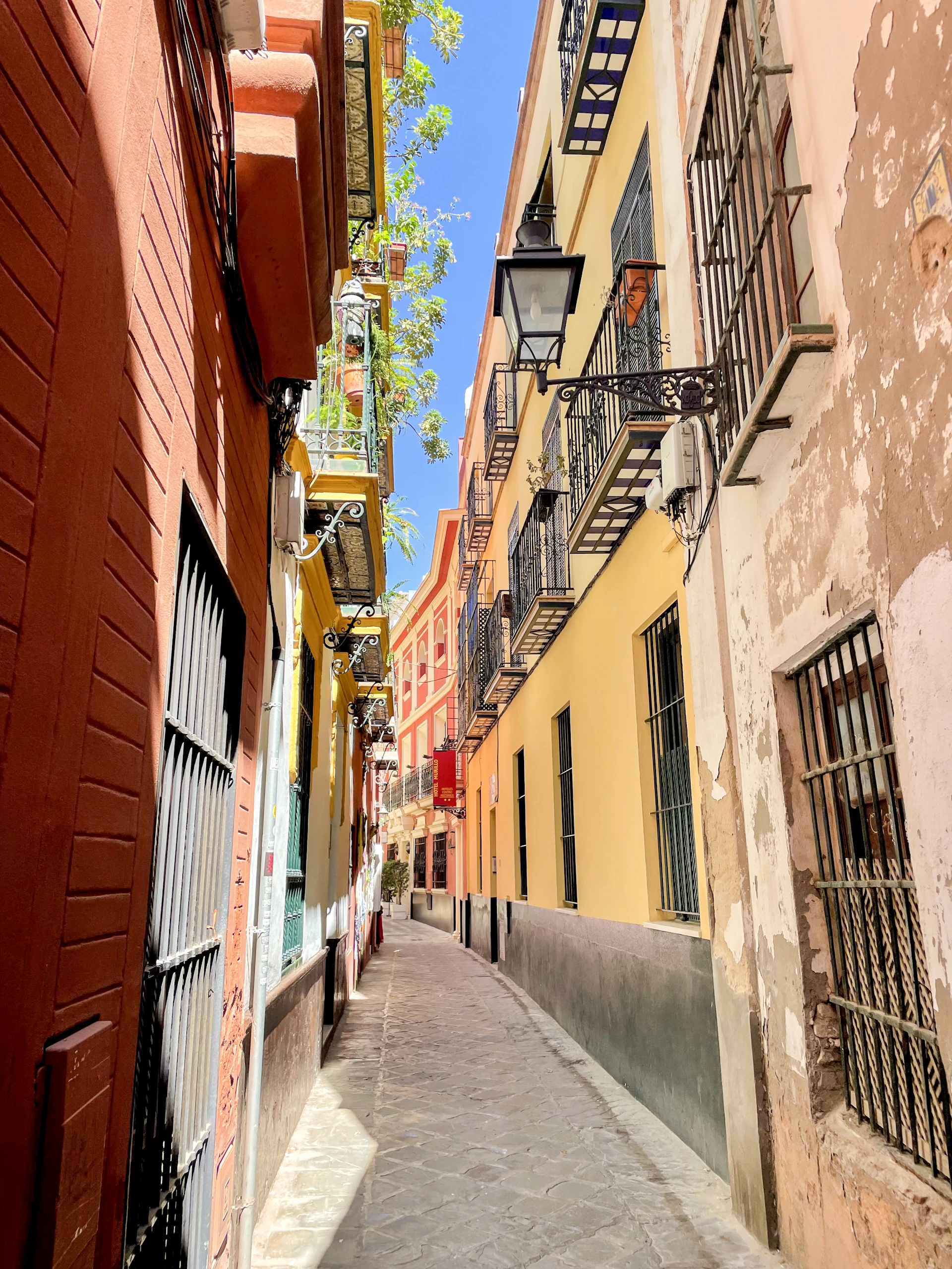 a narrow city street with buildings on both sides