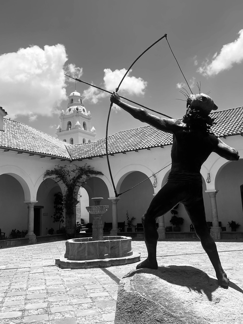a statue of a person holding a bow and arrow