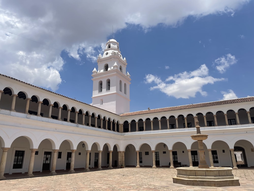 a courtyard with a clock tower in the background