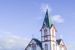 a white and red church with a green steeple