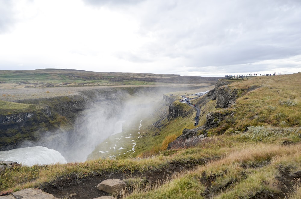 a large waterfall in the middle of a field