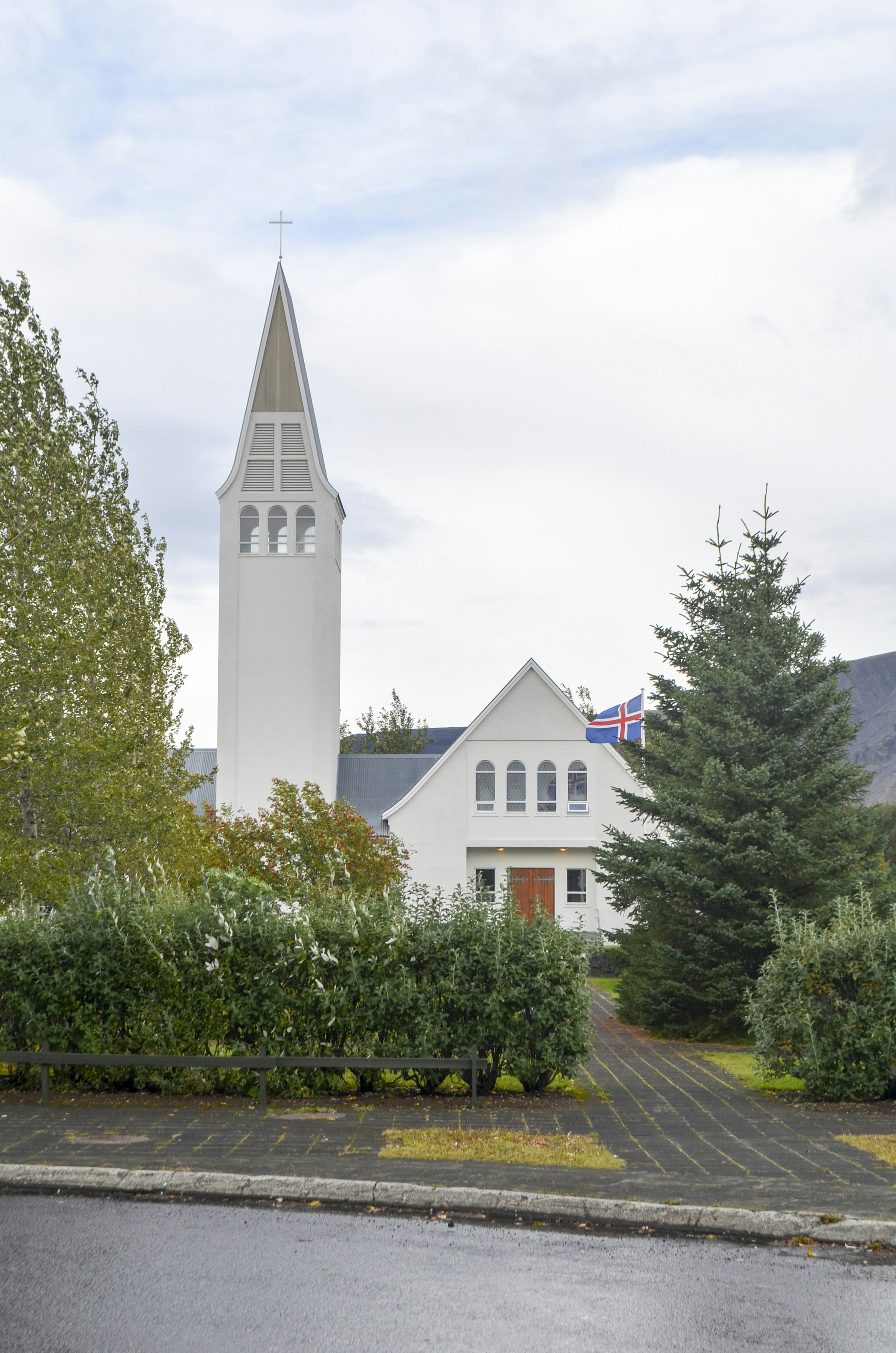 a white church with a steeple and a clock tower