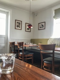 a restaurant with a wooden table and chairs