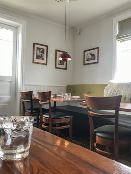 a restaurant with a wooden table and chairs