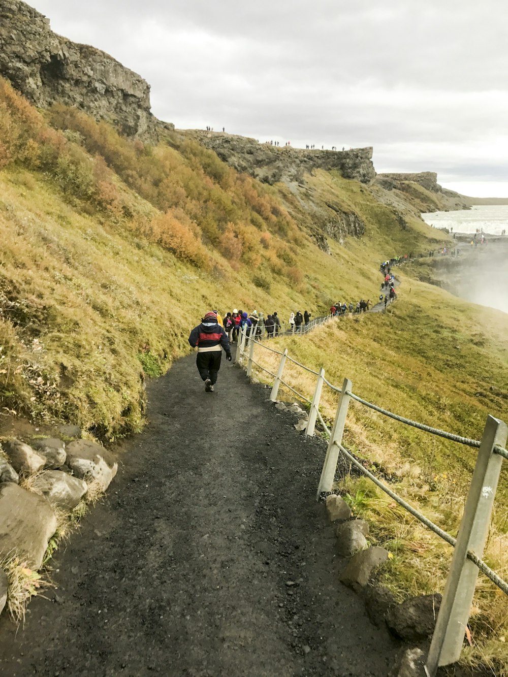 a group of people riding bikes down a dirt road