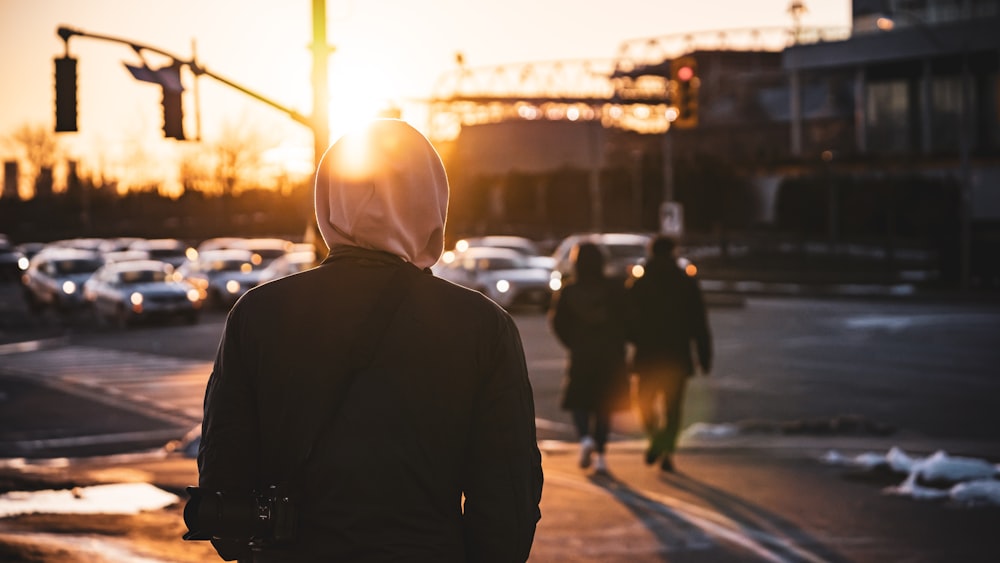 a person in a hoodie walking down a street