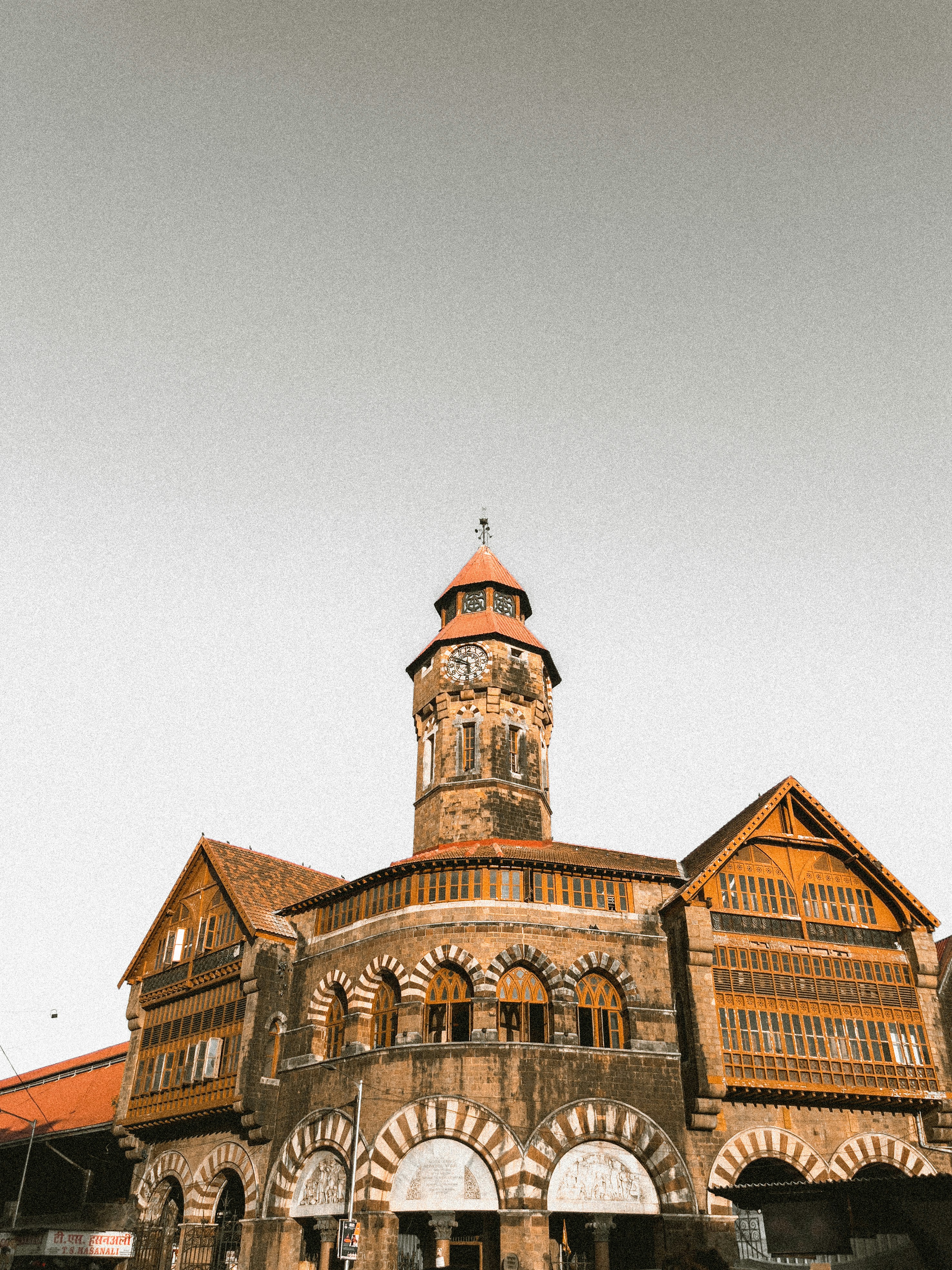 A large building with a clock tower on top of it photo – Free ...