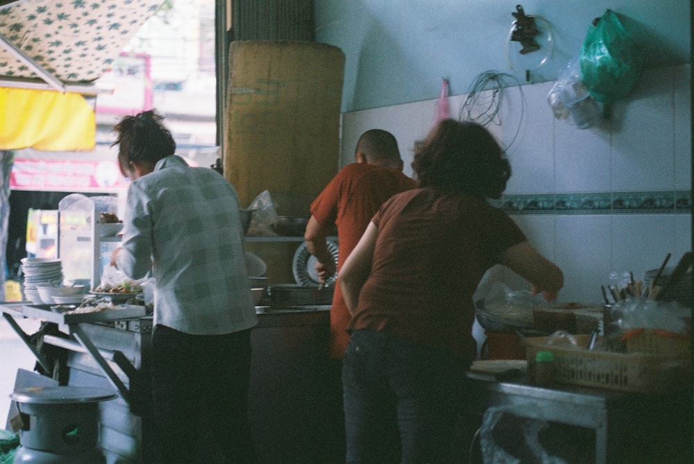 a group of people in a kitchen preparing food