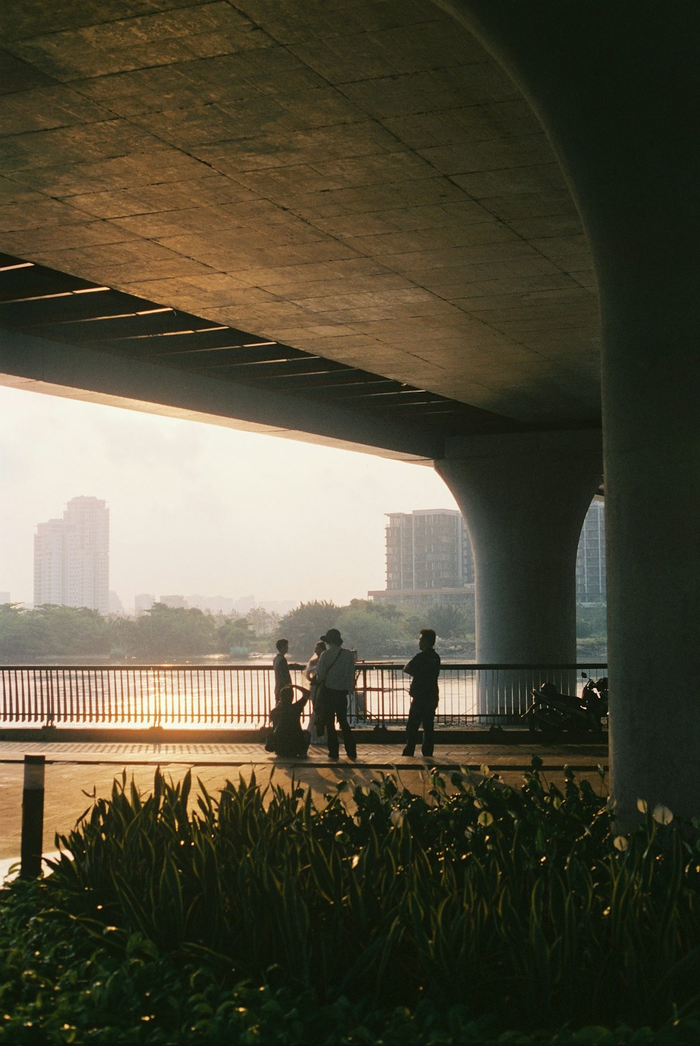 a group of people walking under a bridge