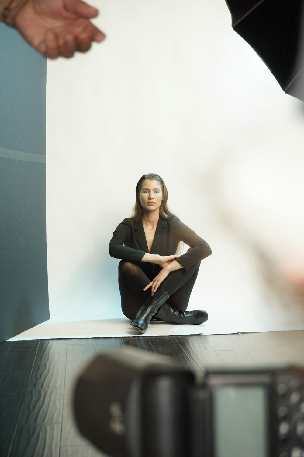 a woman sitting on a table in front of a camera