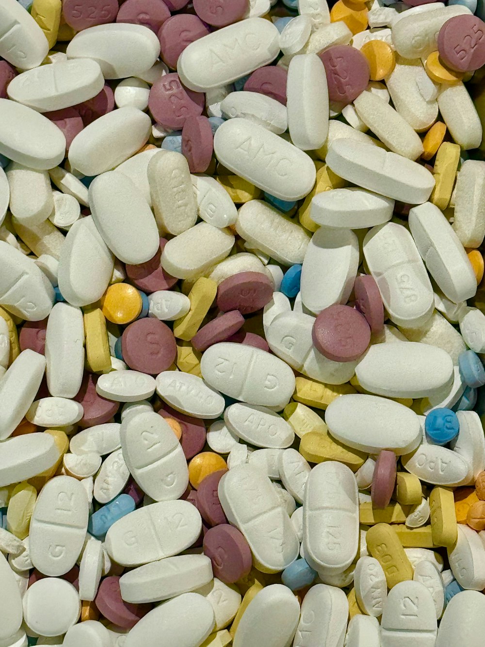 a pile of pills and tablets sitting on top of each other