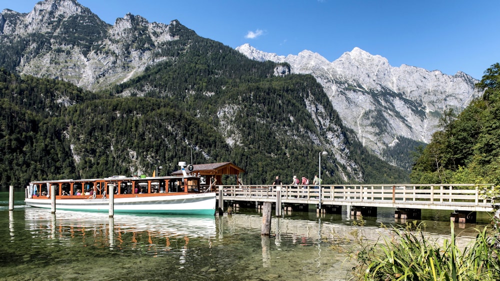 a boat is on the water near a pier