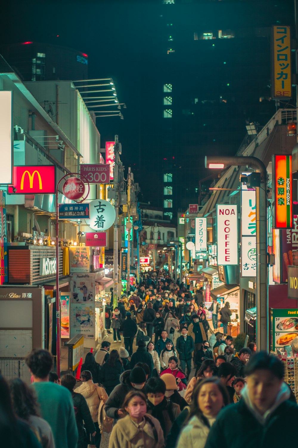 a crowded city street filled with lots of people