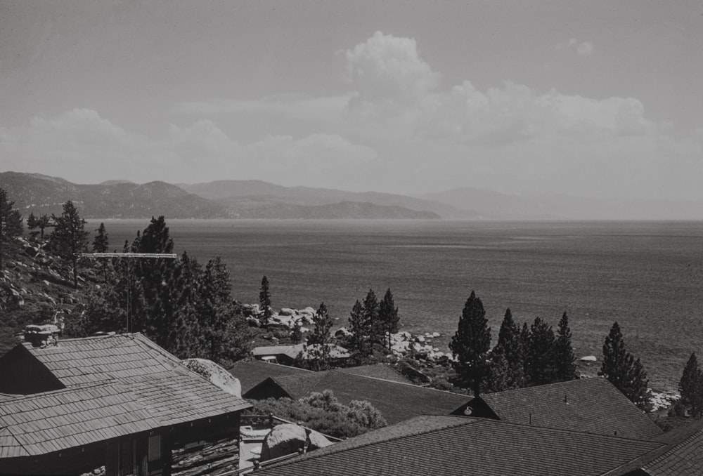 a black and white photo of a town with mountains in the background