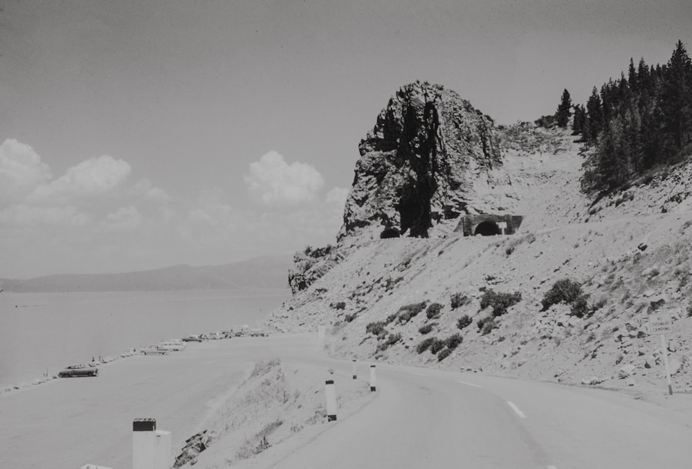 a black and white photo of a mountain road