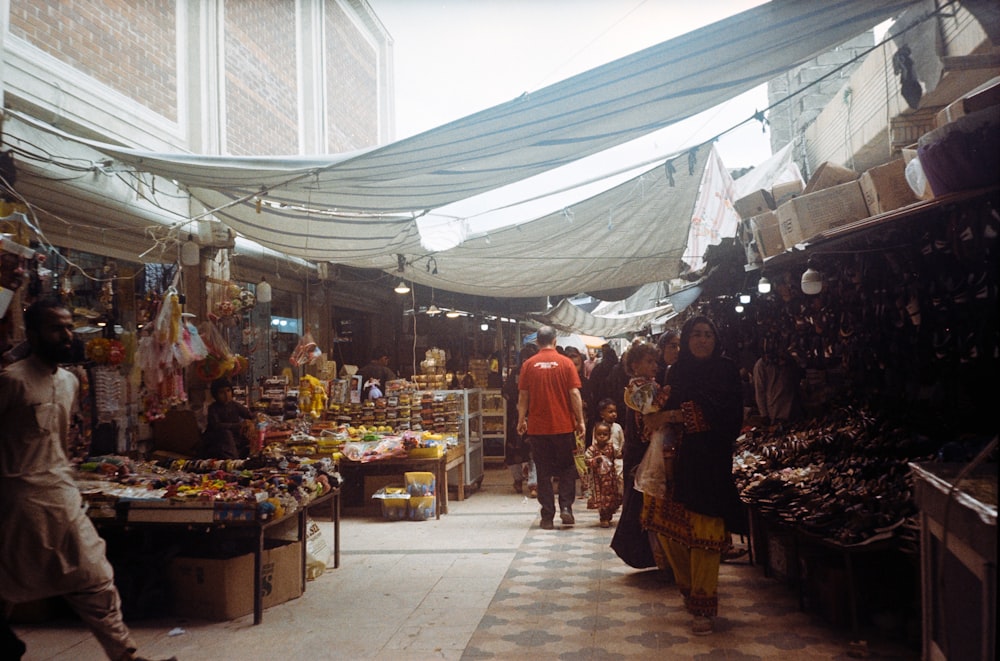 a group of people walking through a market