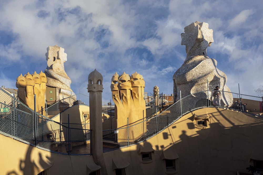 a couple of statues on top of a building