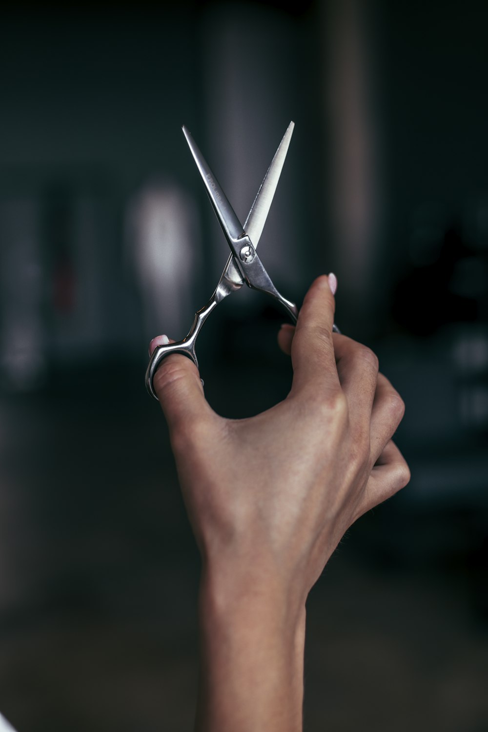a person holding a pair of scissors in their hand