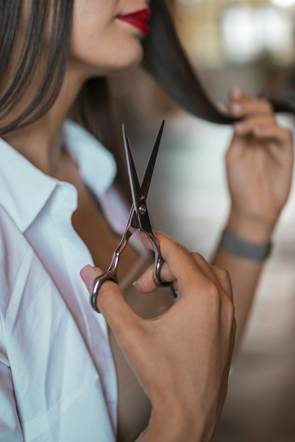 a woman holding a pair of scissors in her hands