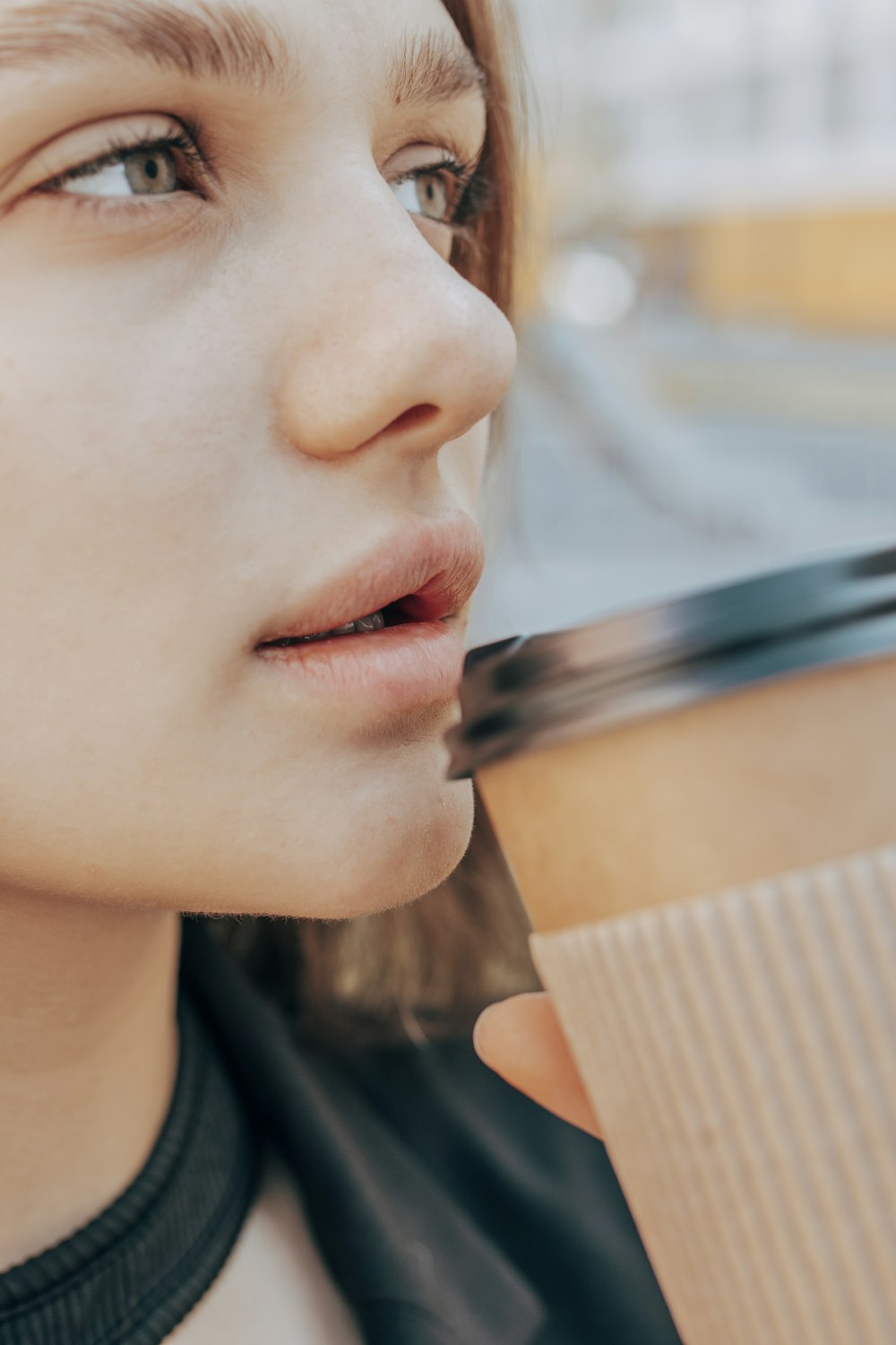 a close up of a person holding a cup of coffee