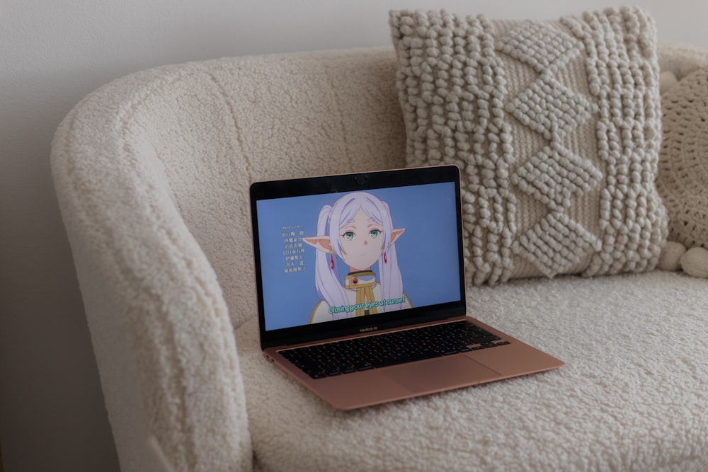 a laptop computer sitting on top of a couch