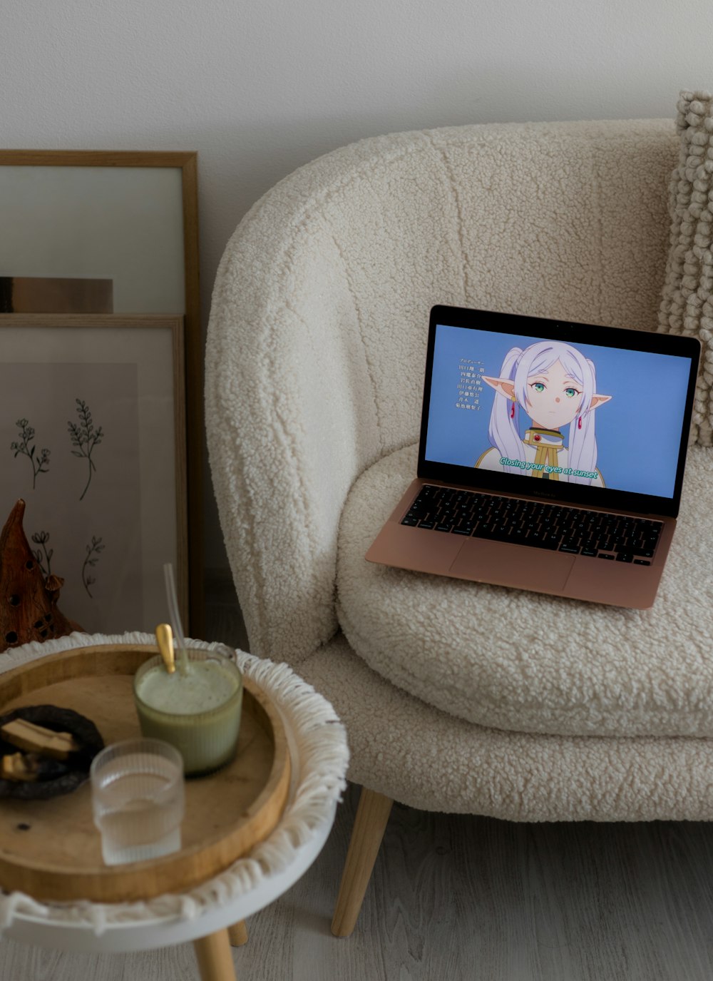 a laptop computer sitting on top of a white chair